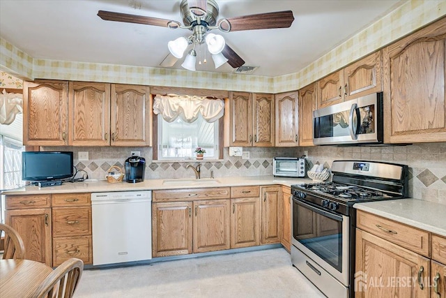 kitchen with tasteful backsplash, sink, and stainless steel appliances