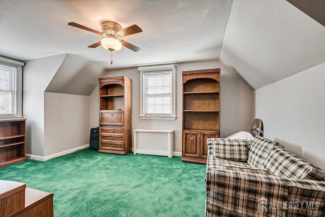 sitting room with radiator, a healthy amount of sunlight, and carpet floors