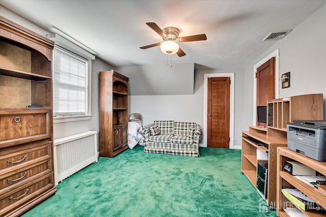 living area with ceiling fan, carpet flooring, and radiator heating unit