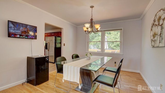 9 Salem Rd, East Brunswick, NJ 08816 - dining space featuring a chandelier, light wood finished floors, crown molding, and baseboards