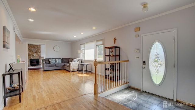 9 Salem Rd, East Brunswick, NJ 08816 - foyer featuring ornamental molding, recessed lighting, a glass covered fireplace, wood finished floors, and baseboards