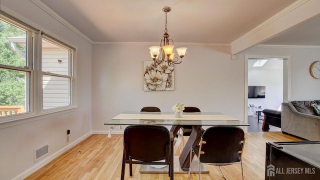 9 Salem Rd, East Brunswick, NJ 08816 - dining room featuring a chandelier, light wood-type flooring, ornamental molding, baseboards, and plenty of natural light