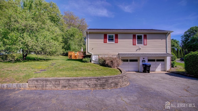 9 Salem Rd, East Brunswick, NJ 08816 - view of side of home with asphalt driveway, an attached garage, and a lawn