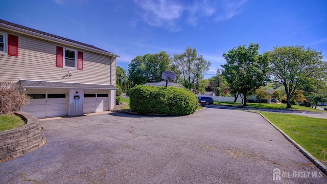 9 Salem Rd, East Brunswick, NJ 08816 - view of property exterior featuring driveway, a garage, and a lawn