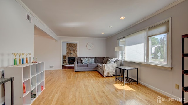 9 Salem Rd, East Brunswick, NJ 08816 - living area featuring ornamental molding, wood finished floors, baseboards, a stone fireplace, and recessed lighting