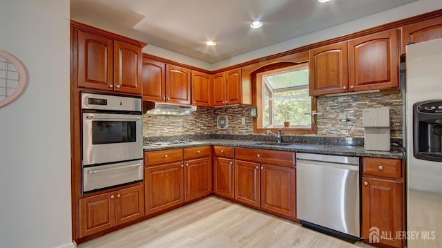 9 Salem Rd, East Brunswick, NJ 08816 - kitchen with appliances with stainless steel finishes, a warming drawer, under cabinet range hood, a sink, and light wood finished floors