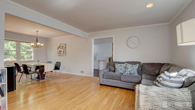 9 Salem Rd, East Brunswick, NJ 08816 - living room featuring light wood-type flooring, a chandelier, crown molding, and baseboards