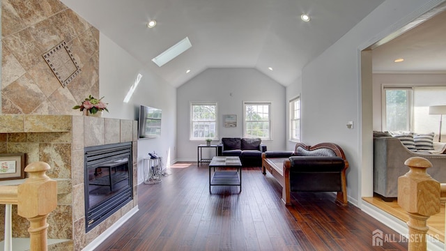 9 Salem Rd, East Brunswick, NJ 08816 - living area with a tile fireplace, dark wood-type flooring, a skylight, recessed lighting, and vaulted ceiling
