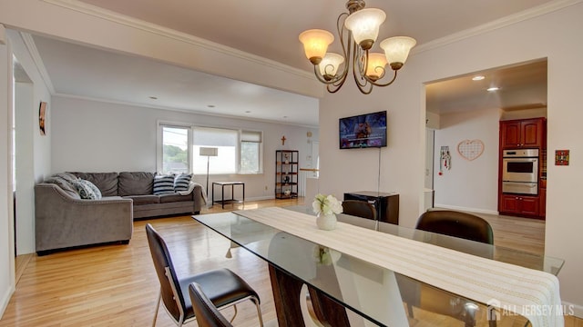 9 Salem Rd, East Brunswick, NJ 08816 - dining space featuring light wood-style floors, a chandelier, crown molding, baseboards, and recessed lighting