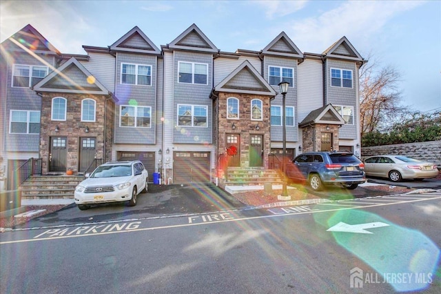 238 Main St, South Amboy, NJ 08879 - townhome / multi-family property with stone siding, driveway, and a garage