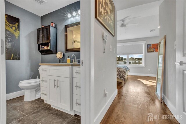 238 Main St, South Amboy, NJ 08879 - bathroom with toilet, ceiling fan, baseboards, and ensuite bath