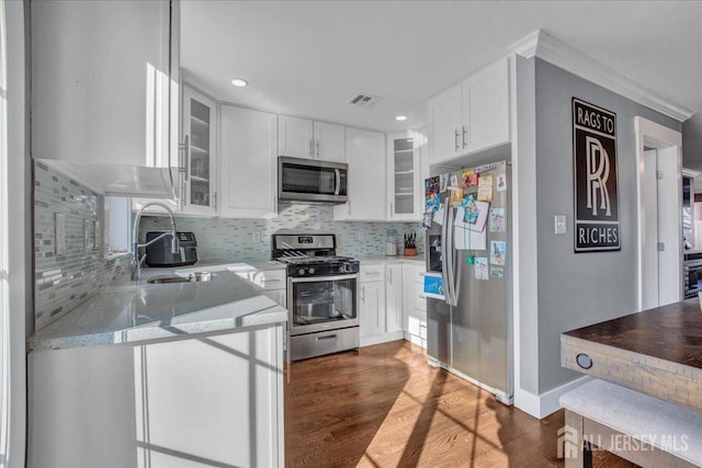 238 Main St, South Amboy, NJ 08879 - kitchen featuring appliances with stainless steel finishes, a sink, white cabinetry, tasteful backsplash, and recessed lighting