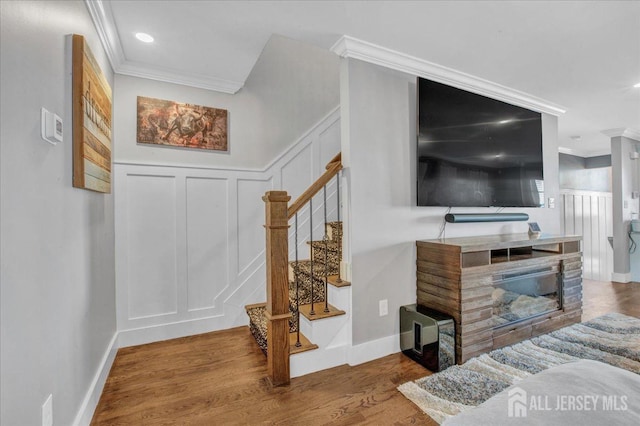 238 Main St, South Amboy, NJ 08879 - living room with a decorative wall, crown molding, stairway, wood finished floors, and baseboards