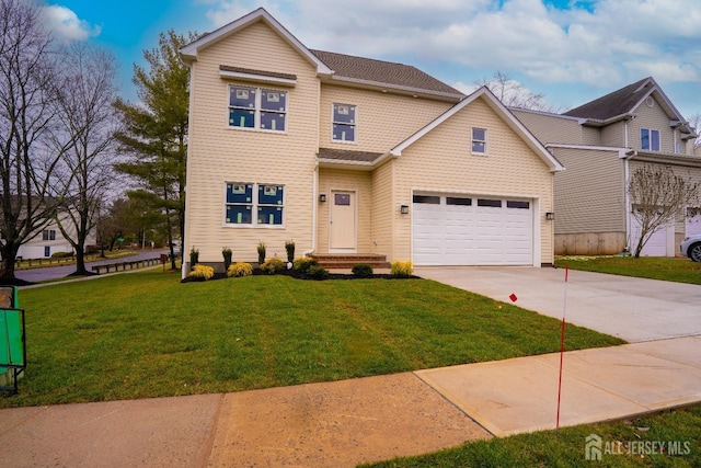 view of front facade with a garage, driveway, and a front lawn