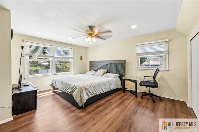 bedroom with hardwood / wood-style floors, baseboards, recessed lighting, ceiling fan, and a closet