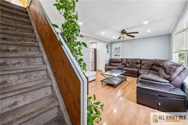 living room with light wood-style flooring, recessed lighting, stairway, ceiling fan, and ornamental molding