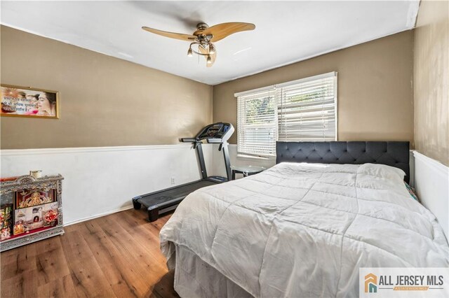 bedroom with wood finished floors and a ceiling fan