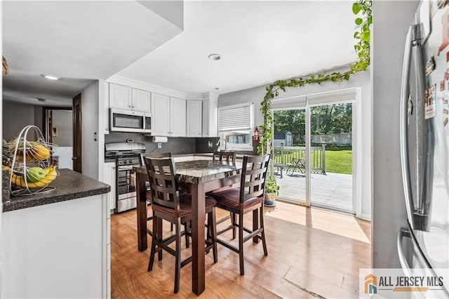 dining room featuring light wood-style floors and recessed lighting