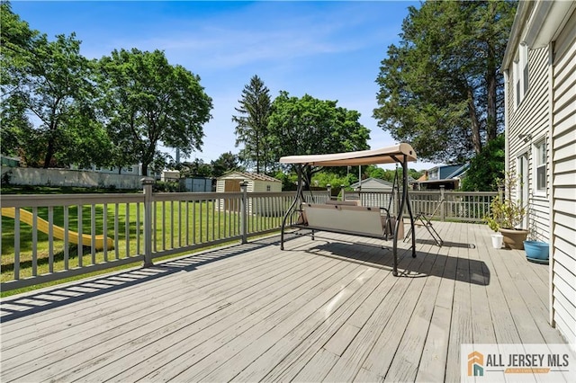 deck with a shed and an outbuilding