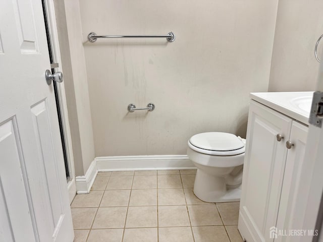 bathroom with tile patterned floors, baseboards, toilet, and vanity