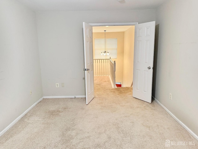 unfurnished bedroom featuring carpet flooring and baseboards