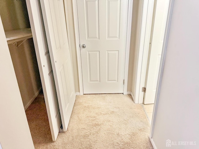 hall with light carpet and baseboards