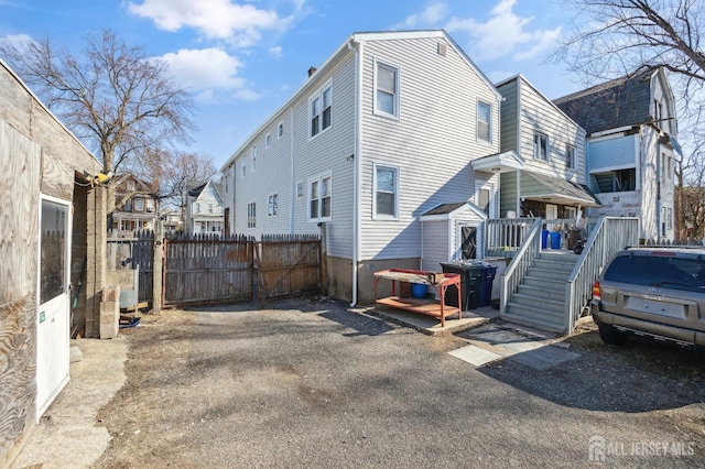 exterior space with a residential view, fence, and a deck