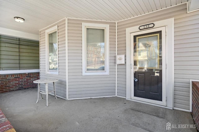 view of exterior entry with covered porch