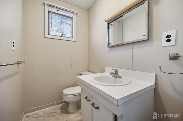 bathroom featuring marble finish floor, vanity, and toilet