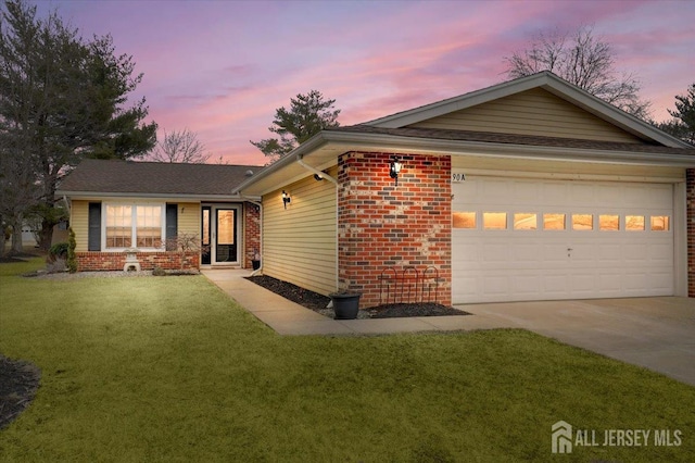 single story home with an attached garage, a yard, concrete driveway, and brick siding