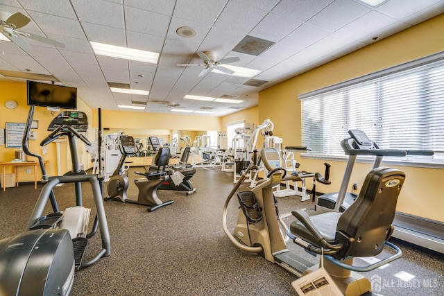 exercise room featuring a paneled ceiling and ceiling fan