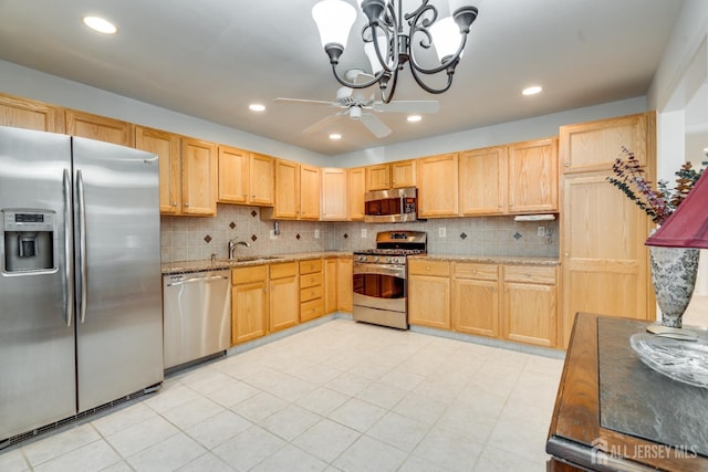 kitchen featuring ceiling fan with notable chandelier, a sink, light brown cabinets, and stainless steel appliances