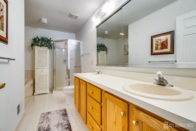 bathroom featuring double vanity, visible vents, a shower stall, and a sink