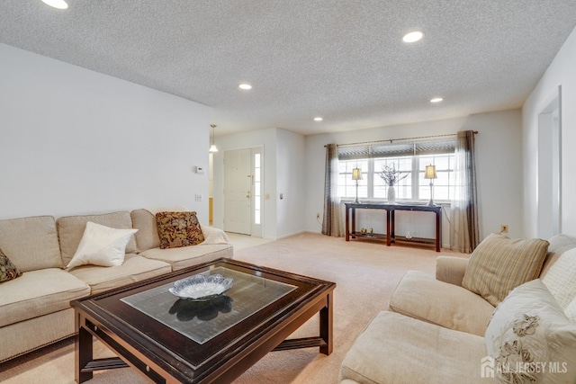 living room featuring recessed lighting, light colored carpet, and a textured ceiling