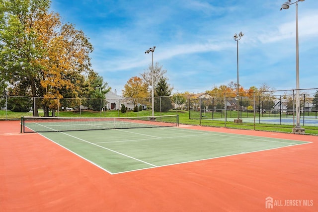 view of sport court featuring community basketball court and fence
