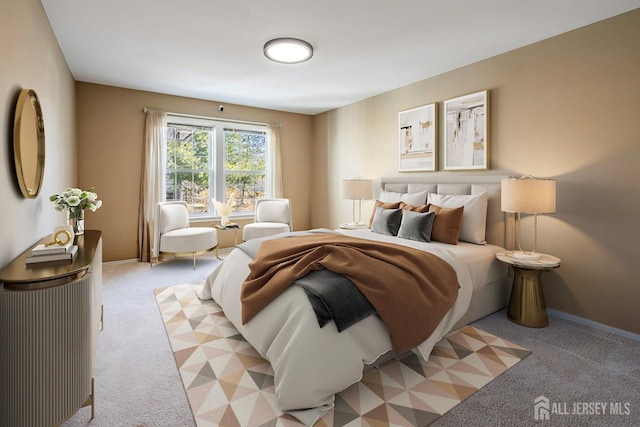 bedroom featuring light carpet and baseboards
