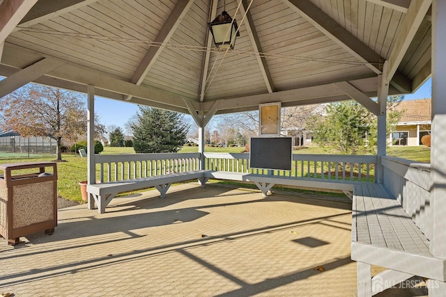 wooden deck featuring a lawn and a gazebo