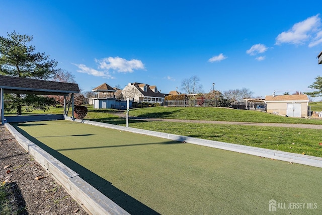 surrounding community featuring a lawn and fence