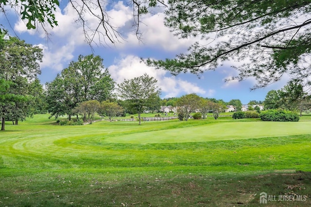 view of home's community featuring a lawn and golf course view