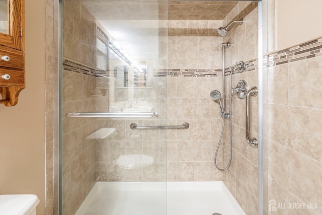 bathroom with a shower with shower door