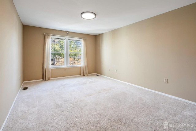 unfurnished room with light carpet