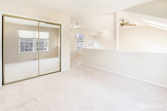 unfurnished bedroom with light carpet and a closet