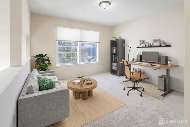 carpeted home office with baseboards