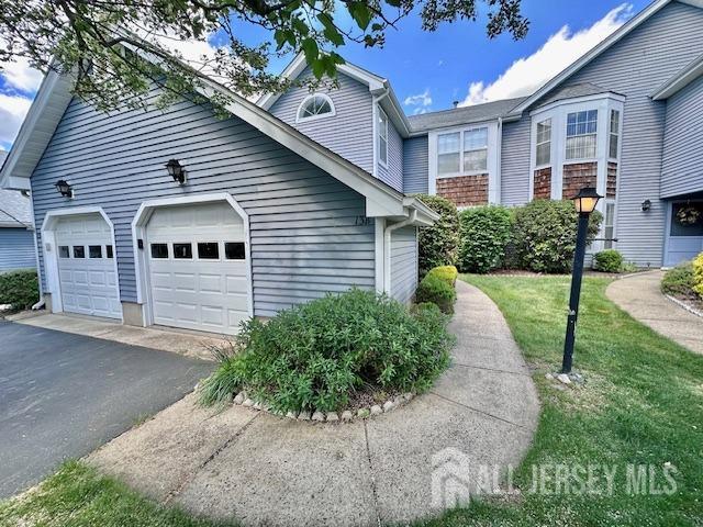 13-B Ashbourne Dr Unit B, Monroe, NJ 08831 - view of front facade with asphalt driveway and a garage
