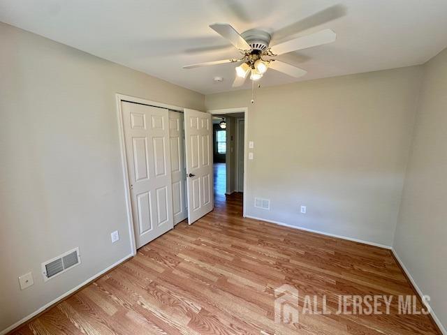 13-B Ashbourne Dr Unit B, Monroe, NJ 08831 - unfurnished bedroom with light wood-type flooring, a closet, and a ceiling fan