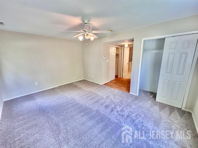 13-B Ashbourne Dr Unit B, Monroe, NJ 08831 - unfurnished bedroom with carpet, a closet, and ceiling fan