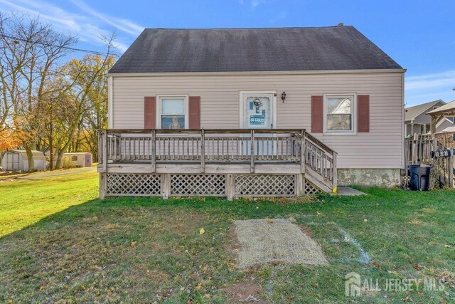 view of front of property featuring a front yard and a wooden deck