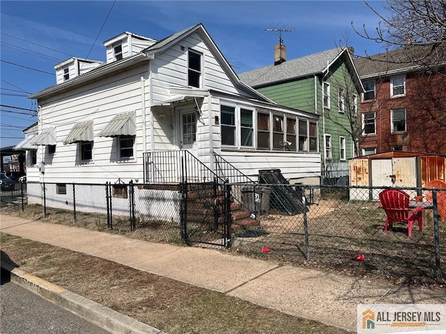 34 Bartlett St, New Brunswick, NJ 08901 - view of front of property with a fenced front yard