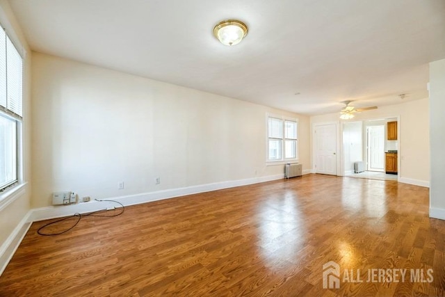 251 Henry St, South Amboy, NJ 08879 - spare room featuring radiator, wood finished floors, baseboards, and a ceiling fan