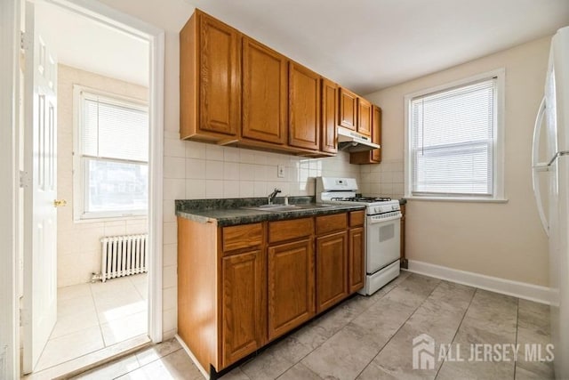 251 Henry St, South Amboy, NJ 08879 - kitchen featuring white appliances, radiator heating unit, brown cabinets, and dark countertops